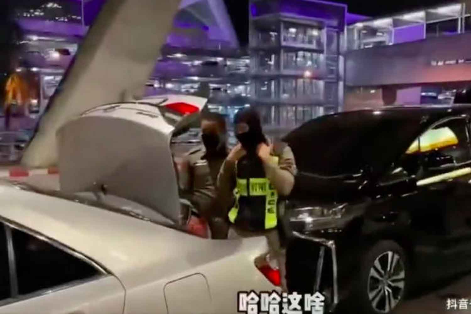 A picture captured from a viral video clip posted by a tourist from Hong Kong show two police officers load her luggage into a car trunk at Suvarnabhumi airport early this month.