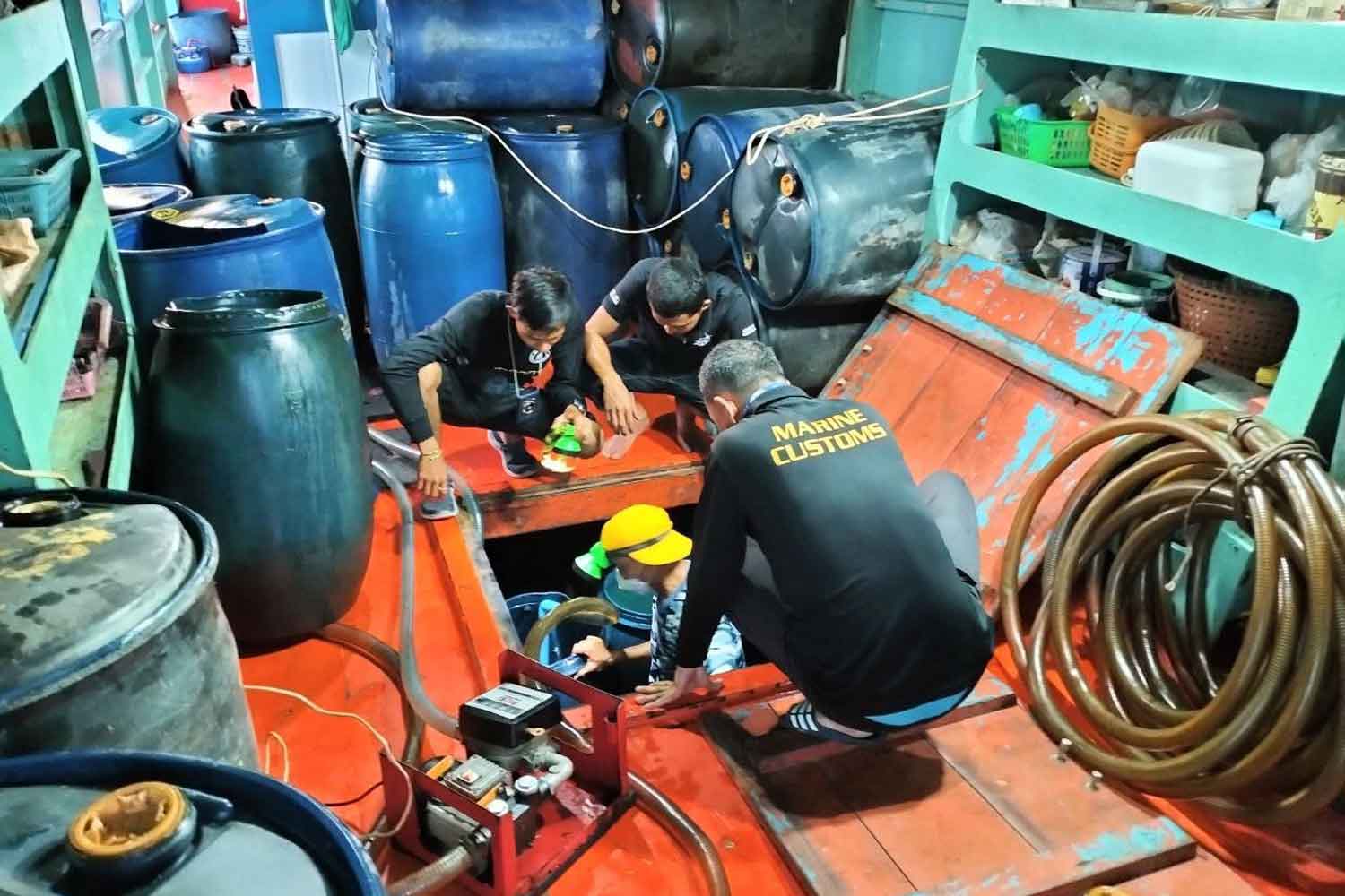 Customs officers aboard the cargo boat found with barrels containing 5,000 litres of contraband petrol, in the sea off Satun on Sunday.(Photo supplied)