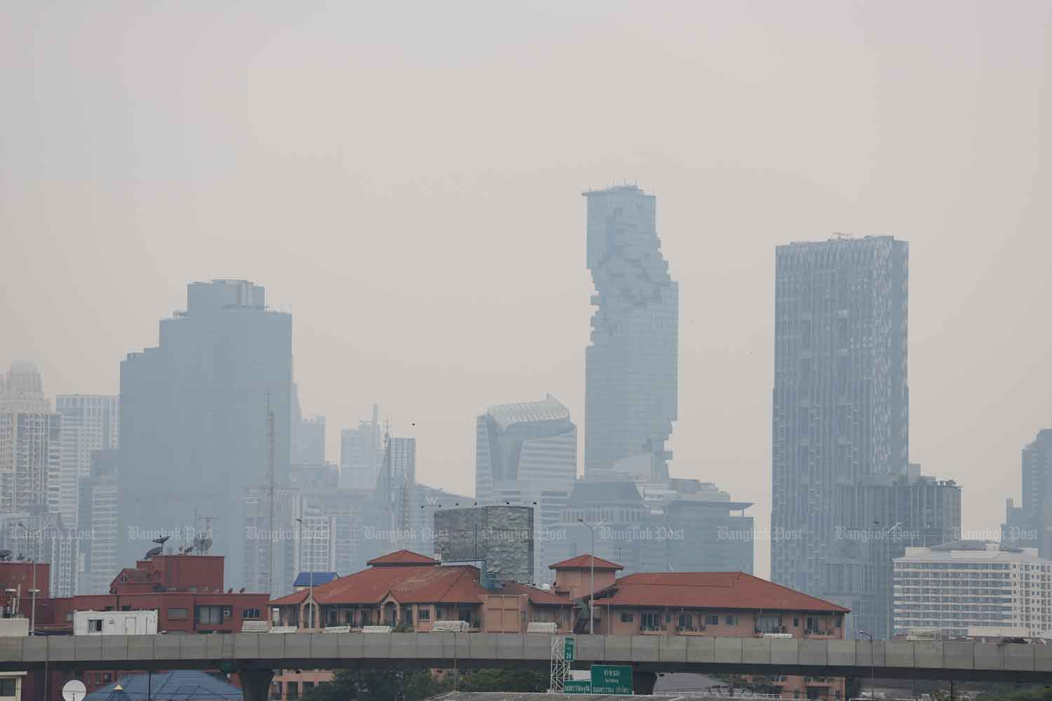 High-rise buildings were shrouded by thick fine dust in Bangkok on Monday afternoon. (Photo: Pornprom Satrabhaya)