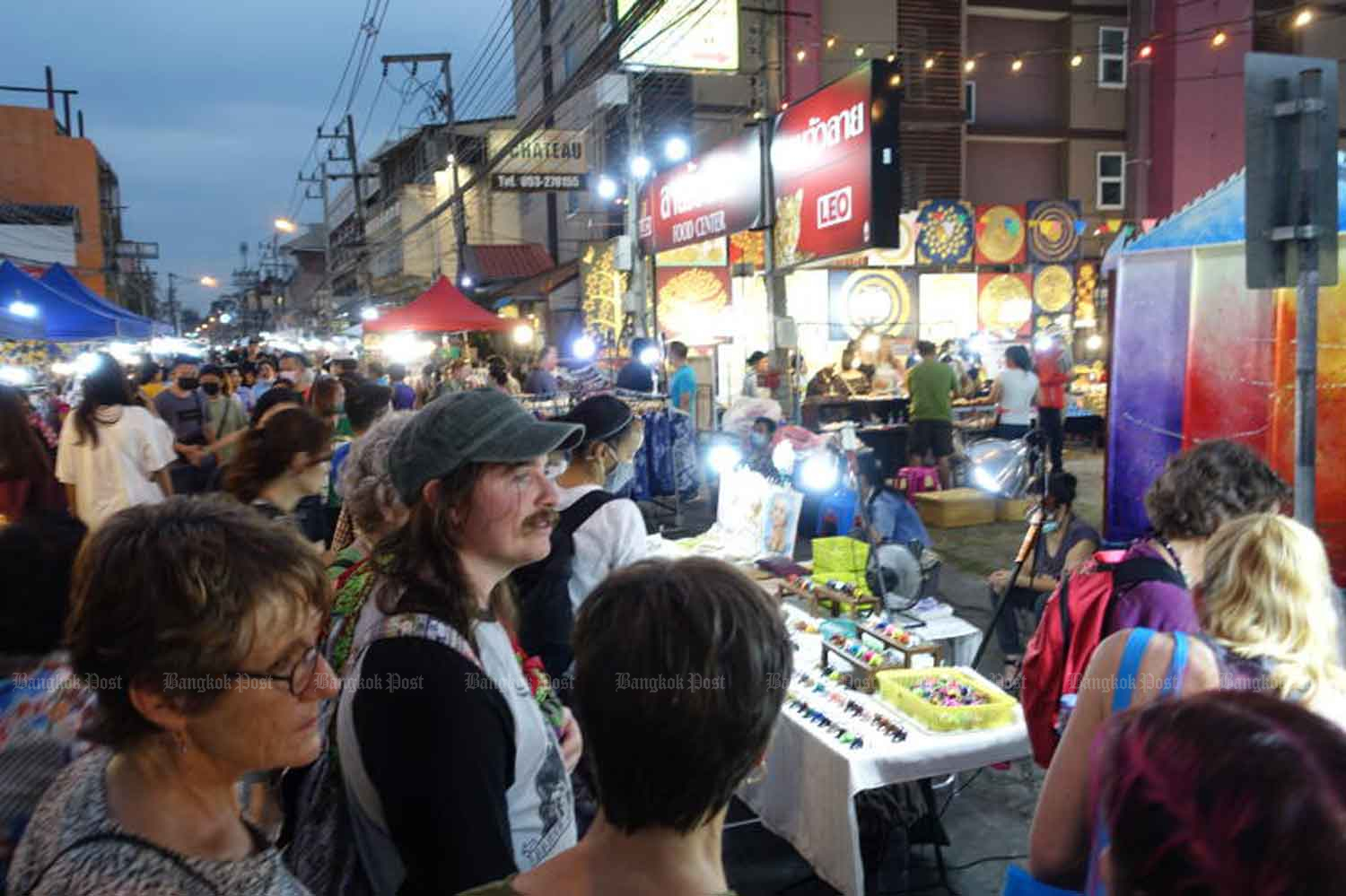 Tourists visit a walking street in the northern province of Chiang Mai in December 2022. (Photo: Varuth Hirunyatheb)