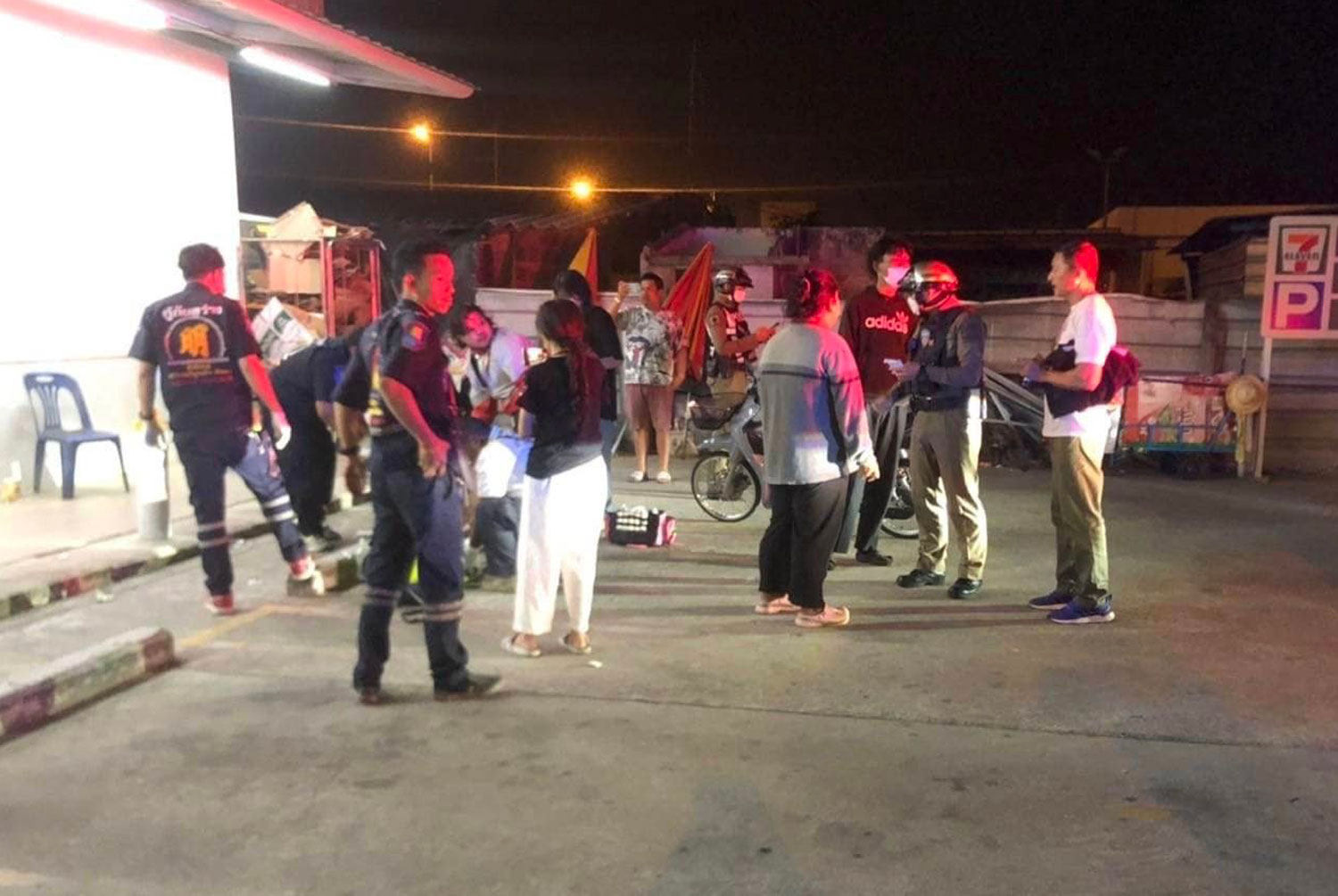 Rescue workers prepare to take two injured people to a hospital after a member of a motorcycle gang threw a Molotov cocktail at them in Pattaya, Chon Buri, in the early hours of Saturday. (Photo: Pattaya rescue team)