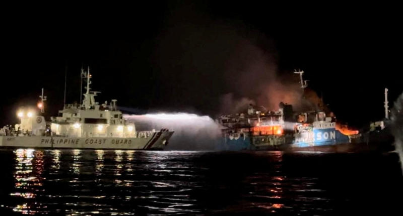 A Philippine Coast Guard vessel sprays water on a fire onboard the Lady Mary Joy 3 during a search and rescue operation in waters off Baluk-Baluk Island in Basilan province on Wednesday. (Photo: Philippine Coast Guard via AFP)