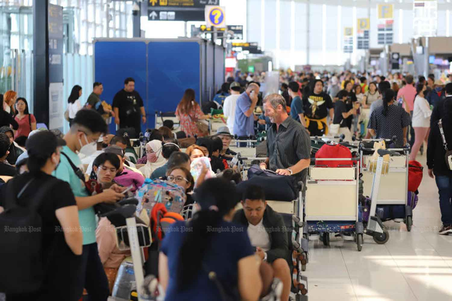 Suvarnabhumi airport is packed with travellers ahead of the busy Songkran holidays from April 13-17. (Photo: Wichan Charoenkiatpakul)