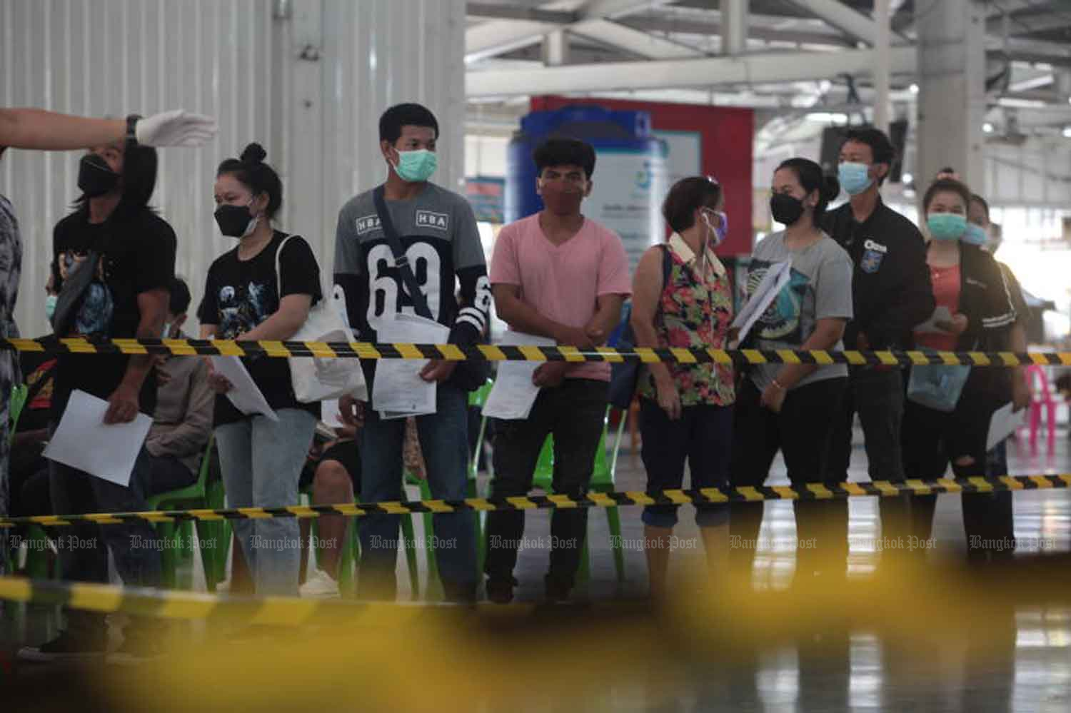 Migrant workers wait for Covid-19 vaccination in Nonthaburi province in 2021. (Photo: Apichart Jinakul)