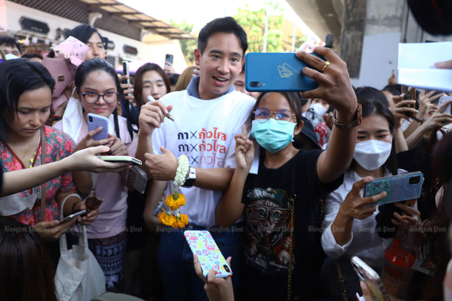 Move Forward Party (MFP) leader Pita Limjaroenrat is surrounded by party supporters during a campaign rally near Victory Monument in Bangkok on May 4. (Photo: Nutthawat Wicheanbut)