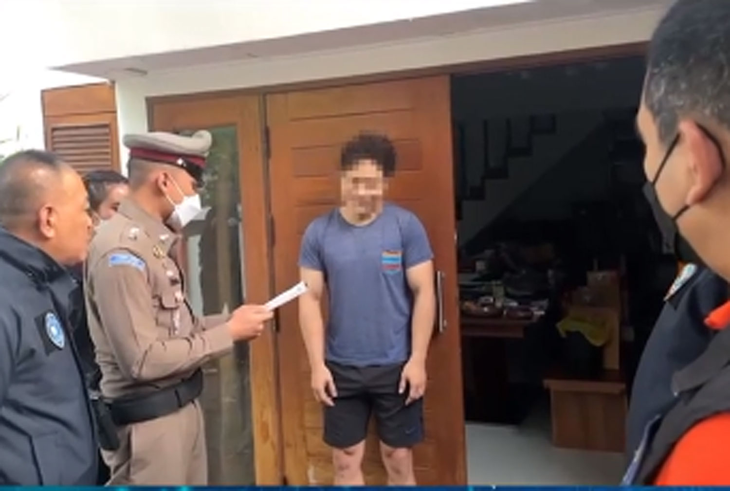 Phattharawit, a former pilot, is arrested at a house in Bangkok's Saphan Sung district on Thursday morning for luring women to have sex and posting clips for payment on social media. (Capture from video by the Cyber Crime Investigation Bureau)