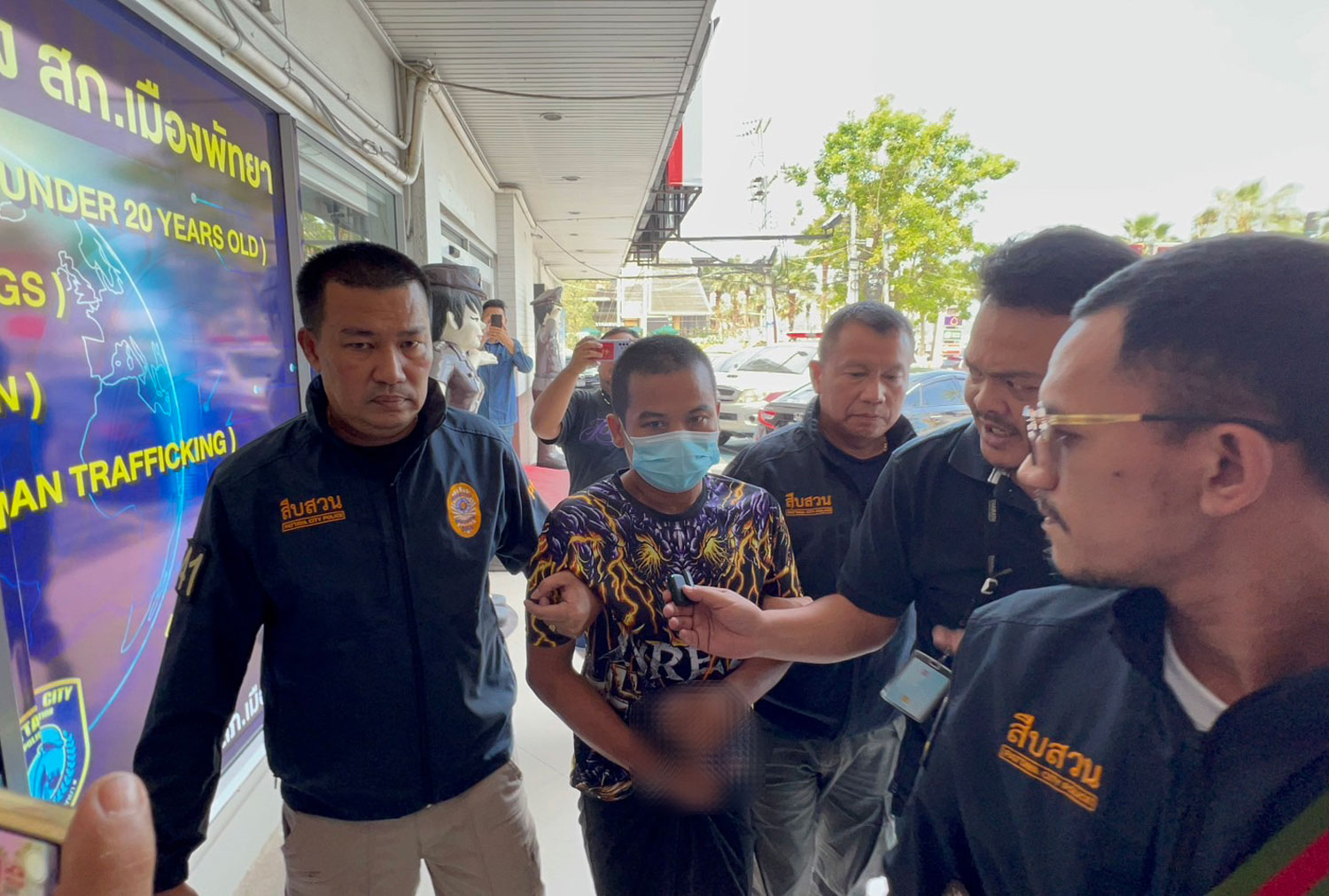 Watcharaphon Onsongkhram, 39, arrives in handcuffs at Pattaya police station in Chon Buri on Wednesday after being arrested in Sakhon Nakhon for the murder of a 32-year-old woman in Pattaya last Saturday. (Photo: Chaiyot Pupattanapong)