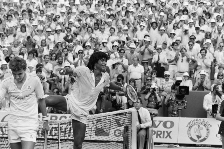 Last man standing: Yannick Noah cries with joy and steps over the net after winning the 1983 French Open. (File photo)