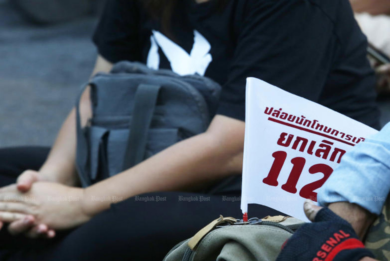 Pro-democracy activists take part in a sign-up campaign for the scrapping of Section 112 or lese majeste law at Ratchaprasong intersection in Bangkok on December 12, 2021. (Photo: Apichit Jinakul)