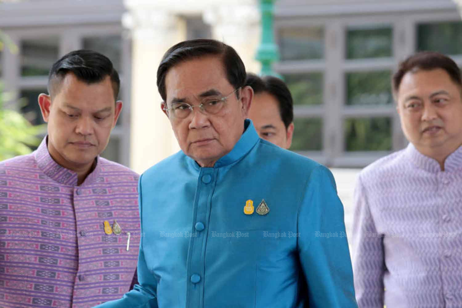 Prime Minister Prayut Chan-o-cha walks past reporters at Government House on Tuesday. (Photo: Chanat Katanyu)