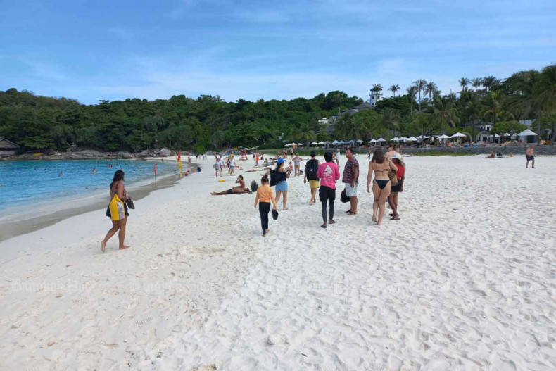 Tourists relax on a beach on Ko Racha Yai island, Phuket in January. (Photo: Achadthaya Chuenniran)