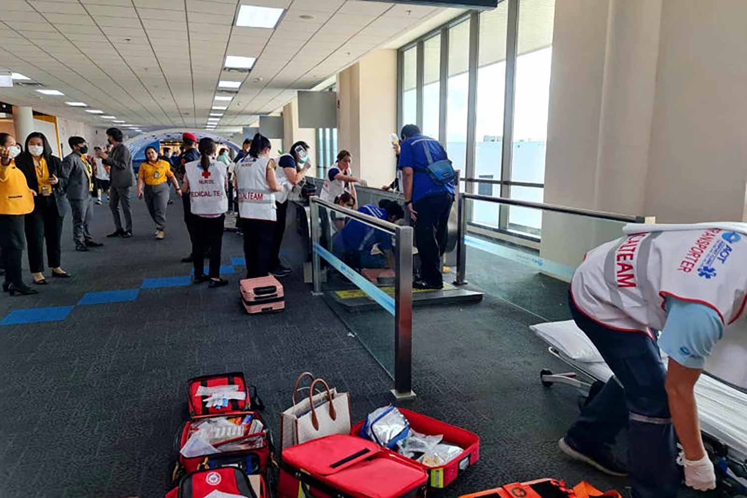 Airports of Thailand medics help an injured woman after her leg became caught in a moving walkway at Don Mueang airport on June 29. (Photo from Don Mueang International Airport-DMK Facebook page)