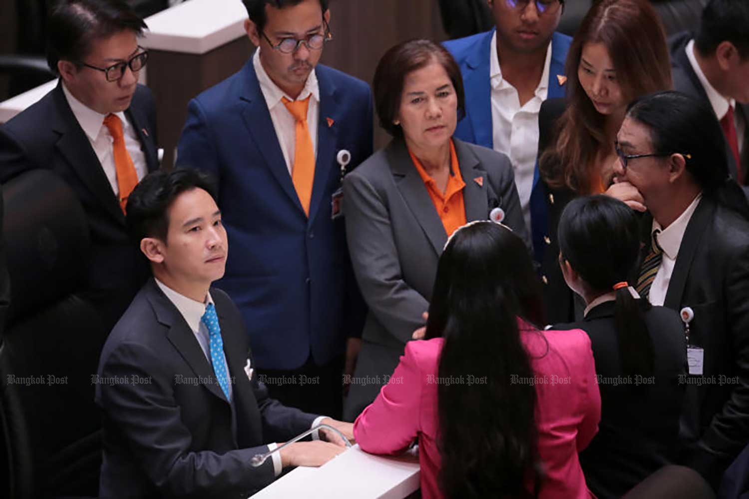 Move Forward leader Pita Limjaroenrat, seated left, consults with party MPS during the joint sitting of the House and the Senate to consider his renomination for prime minister on July 19. (Photo: Chanat Katanyu)