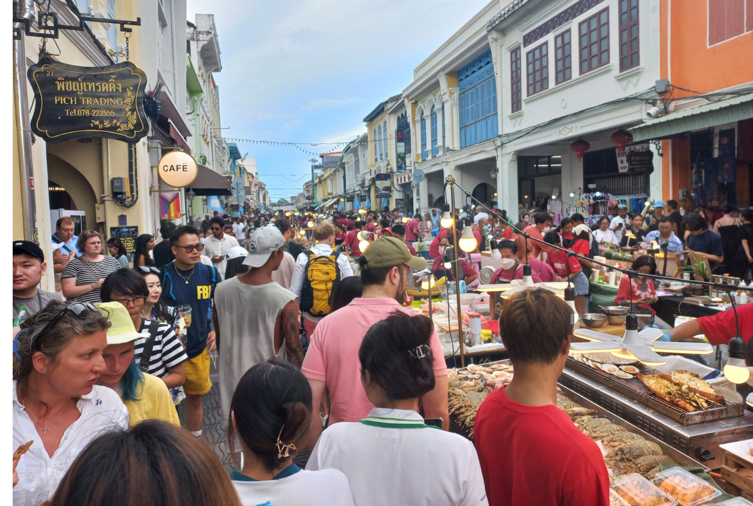 Tourists throng the walking street in the Old Town area in central Phuket. (Photo: Achathaya Chuenniran)