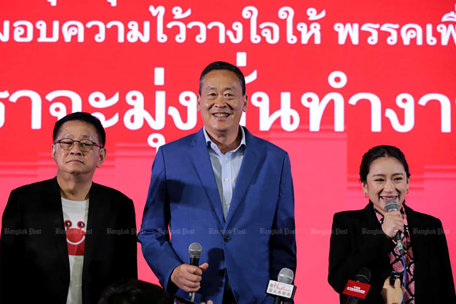 Pheu Thai prime ministerial candidate Srettha Thavisin, centre, with Paetongtarn Shinawatra, right, and secretary-general Prasert Chanthararuangthong, left, after the general election on May 14. (Photo: Chanat Katanyu)