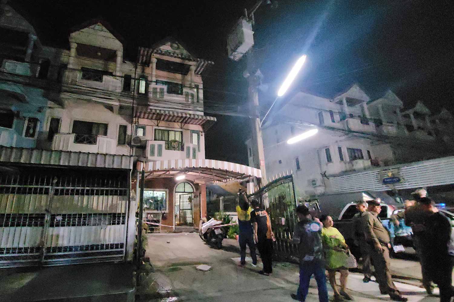 Police at the three-storey townhouse where a woman and her two sons were killed and her husband was found severely injured, in Bang Phli district of Samut Prakan early Monday morning. (Photo: Sutthiwit Chayutworakan)