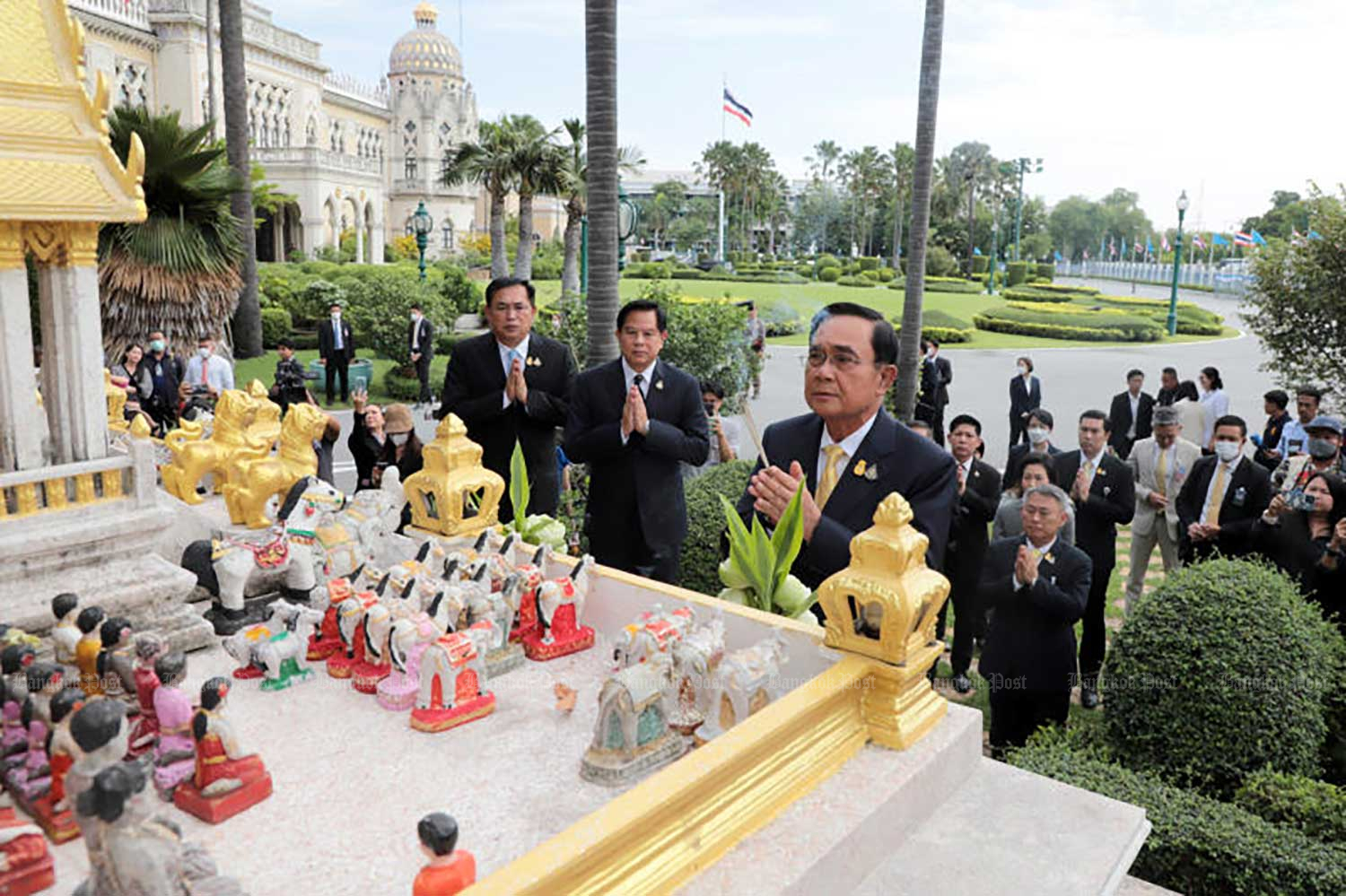 Outgoing Prime Minister Prayut Chan-o-cha pays respect to shrines at Government House on Thursday morning. He said it would be the last day of his prime ministerial work at Government House. (Photo: Chanat Katanyu)