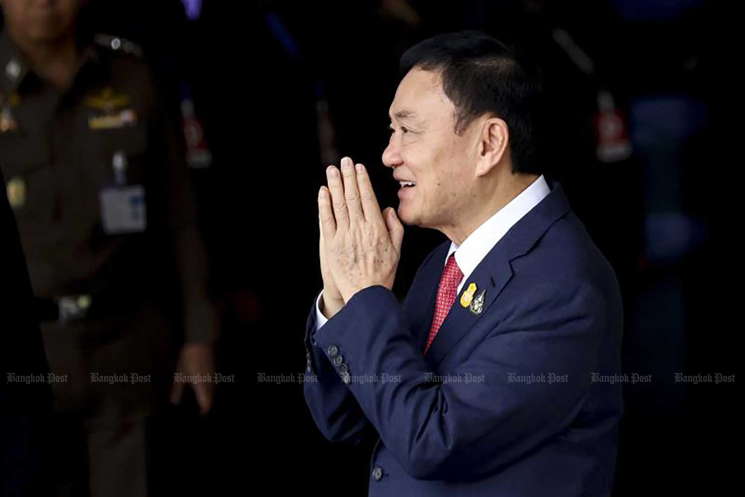 Former prime minister Thaksin Shinawatra greets supporters after arriving at Don Mueang airport on Aug 22. (Photo: Pattarapong Chatpattarasill)