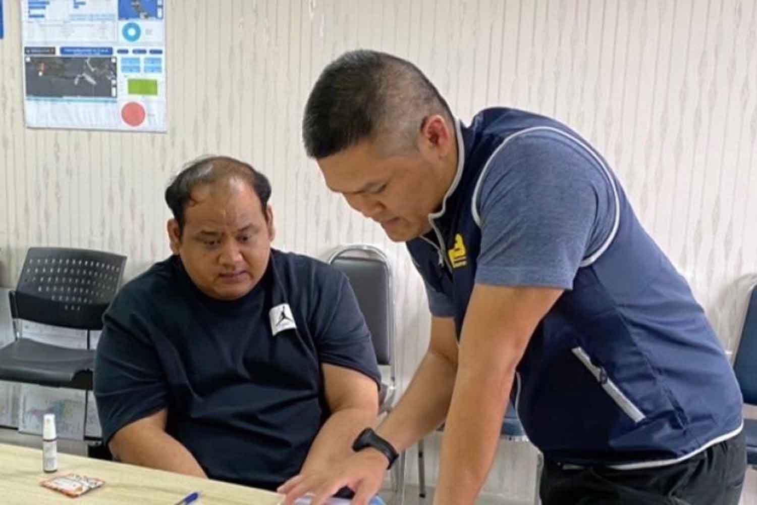 Praween Chankhlai, alias Kamnan Nok, left, undergoes questioning by police from the Crime Suppression Division in Bangkok two weeks ago after two highway police officers were shot during a party at his house in Nakhom Pathom province. Many senior police officials were in attendance at the influential local administrator's house. (Photo supplied)