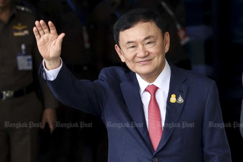 Former prime minister Thaksin Shinawatra waves to his supporters as he arrives at Don Muang Airport on Aug 22. (Photo: Pattarapong Chatpattarasill)