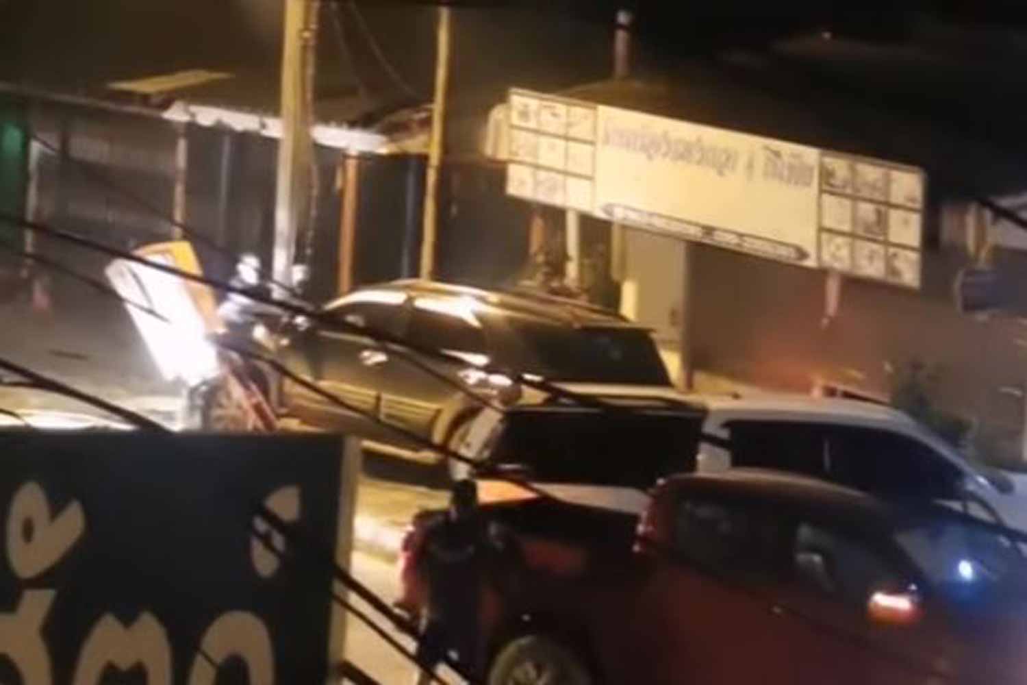 The fleeing black Toyota Fortuner comes to a stop after its hits a power pole and a road sign, immediately before the fatal shooting in Wiang Chai district of Chiang Rai on Tuesday night. (Screenshot)