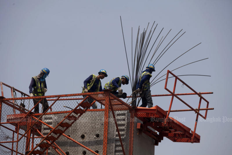 Labourers at a construction site on Charansanitwong Road in Bangkok. (Photo: Pawat Laopaisarntaksin)