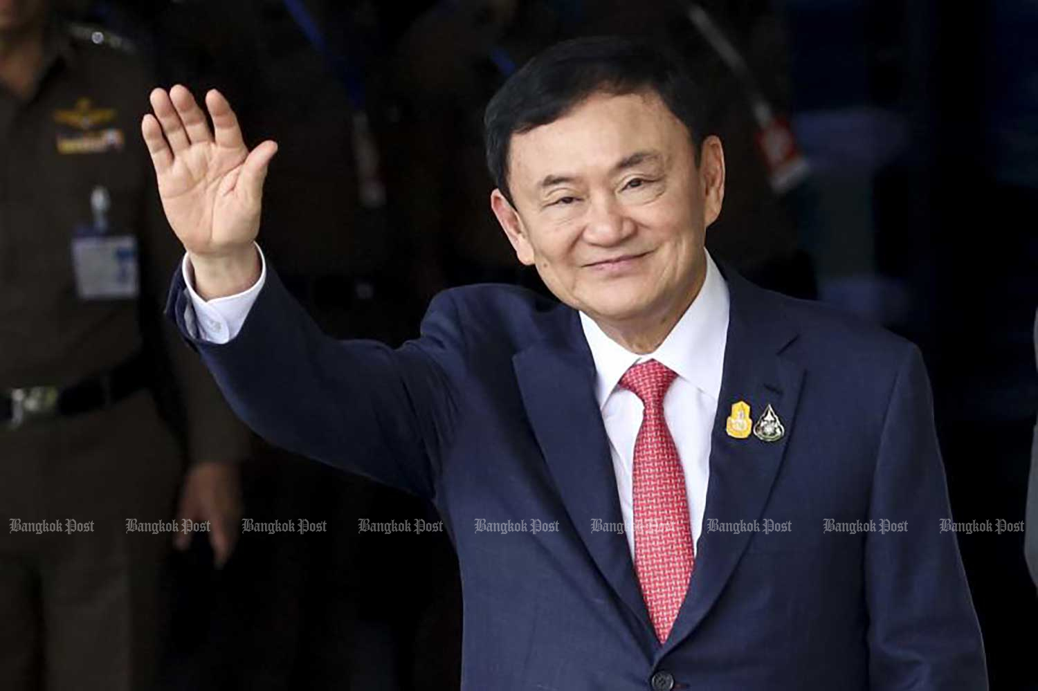 Former prime minister Thaksin Shinawatra waves to supporters shortly after he arrives at Don Mueang airport on Aug 22, returning from years in self exile. (Photo: Pattarapong Chatpattarasill)