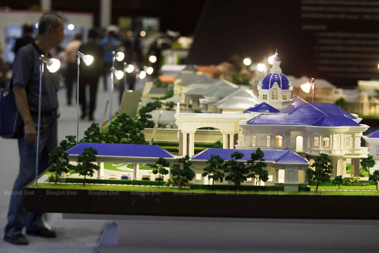 Models of luxury houses are on display at a house and condo fair held in Bangkok. The inheritance tax being considered applies to assets worth more than 100 million baht. Pawat Laupaisarntaksin