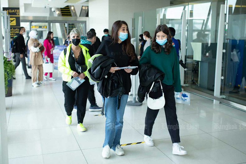 Visitors arrive at Phuket airport in December 2021. (Photo: Achadthaya Chuenniran)