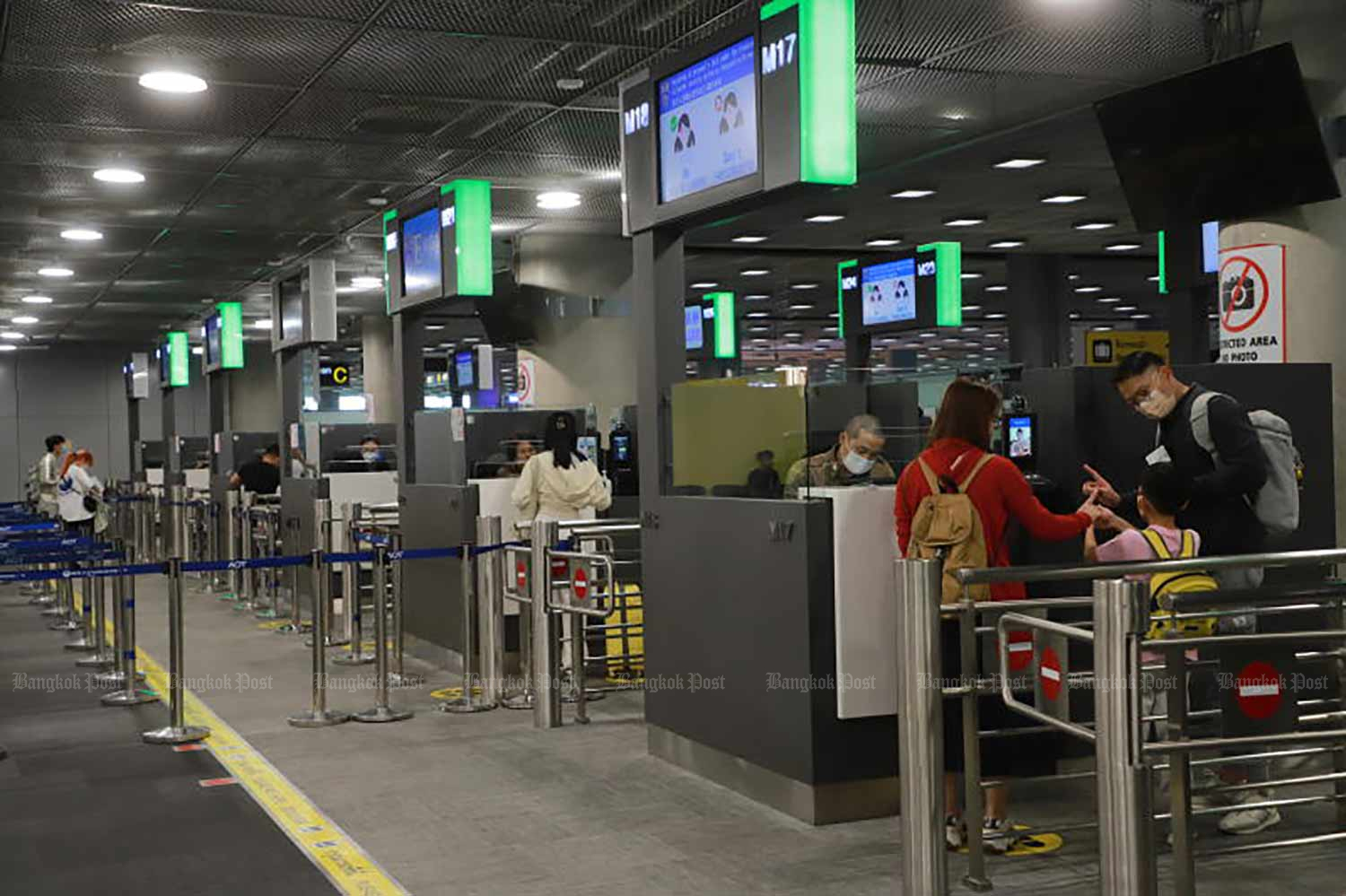 Immigration officers work at Suvarnabhumi airport in February. (Photo: Somchai Poomlard)