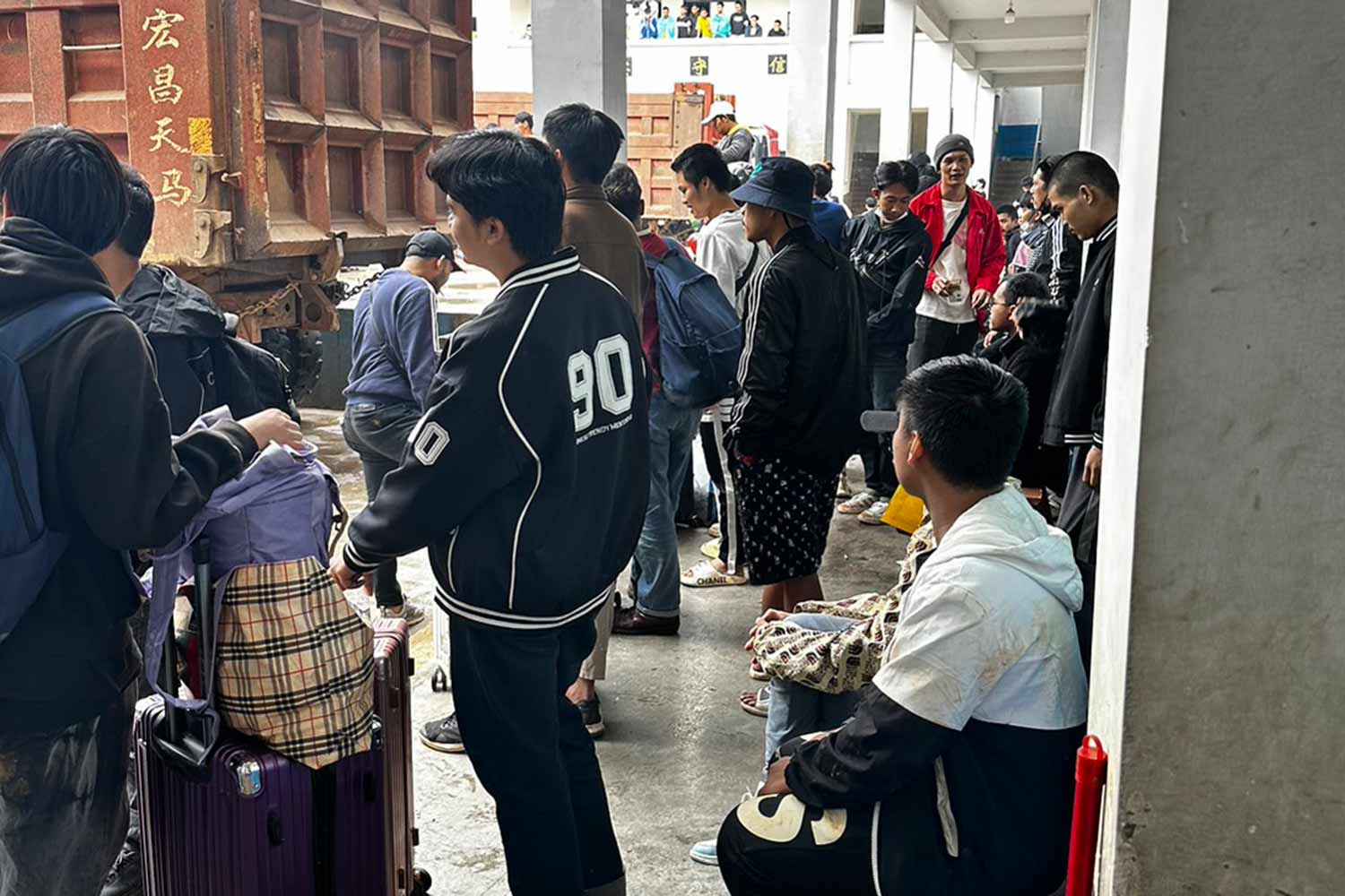 Thai evacuees wait for transportation after being rescued from Laukkaing in northern Myanmar on Sunday. (Photo supplied)