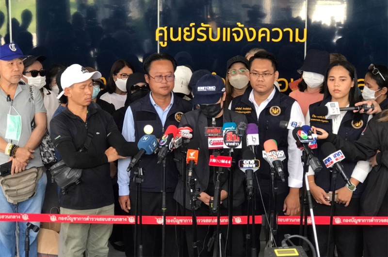 A woman tells reporters about her investment with a firm running an online business as she joins about 20 others to file a fraud complaint against The iCon Group with consumer protection police on Thursday in Bangkok. (Photo supplied/Wassayos Ngamkham)