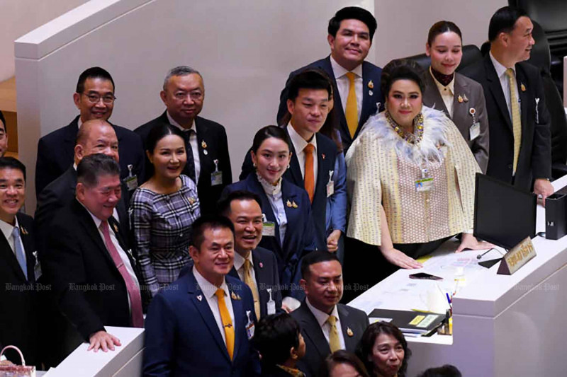 Prime Minister Paetongtarn Shinawatra, centre, stands with Opposition Leader Natthaphong Ruengpanyawut, who went to greet her after the premier survived a no-confidence motion on March 26. (Photo: Nutthawat Wichieanbut)