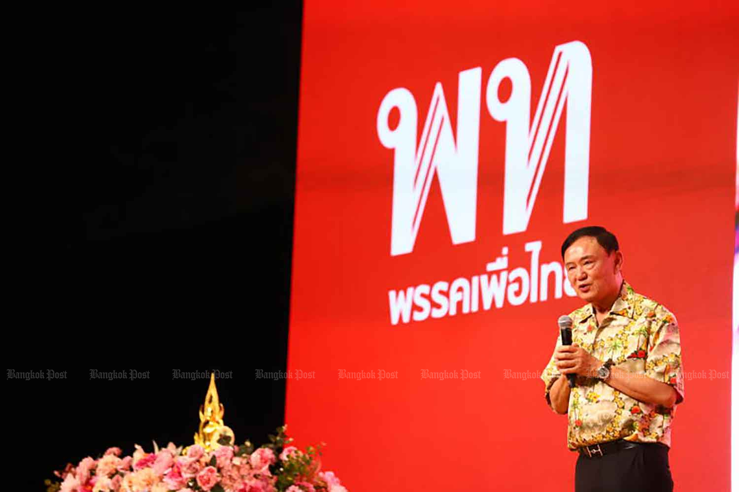 Thaksin Shinawatra speaks to members of the ruling Pheu Thai Party.