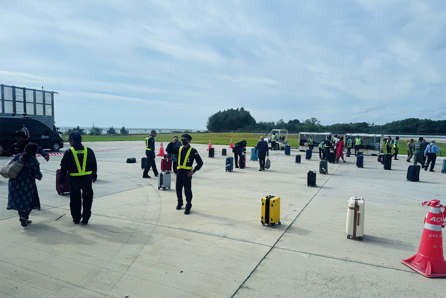 Phuket airport staff help escort all 156 passengers safely from the Air India Airbus A320 jet on Friday. (Photo: Achadthaya Chuenniran)