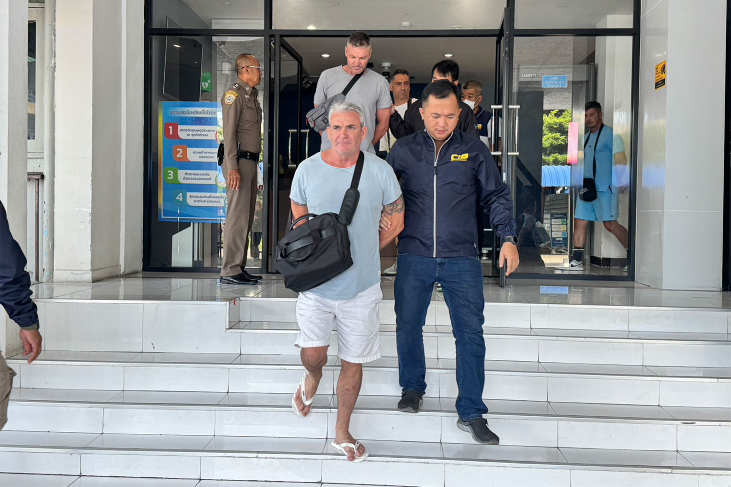 Thirteen foreign nationals suspected of running a scam call centre targeting Australian citizens are taken to the Criminal Court on Wednesday. (Photo supplied/Wassayos Ngamkham)