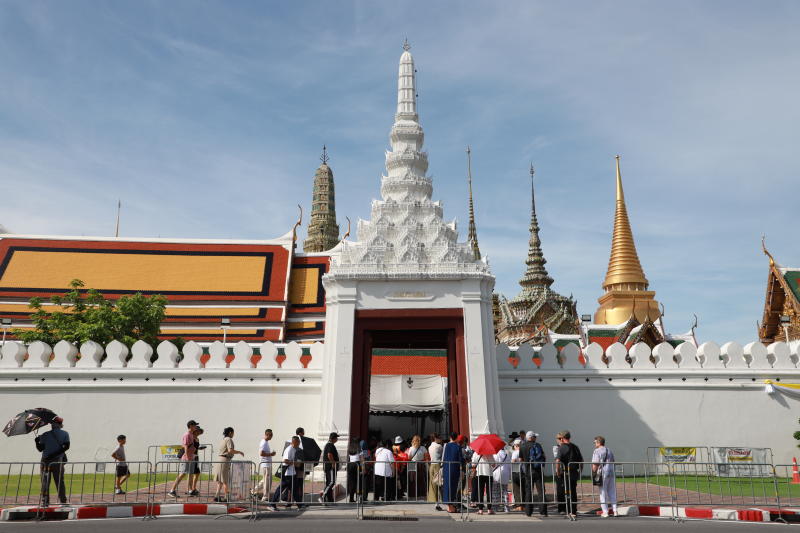 Tourists wait outside a Grand Palace gate in Bangkok in June 2025. (Photo: Somchai Poomlard)