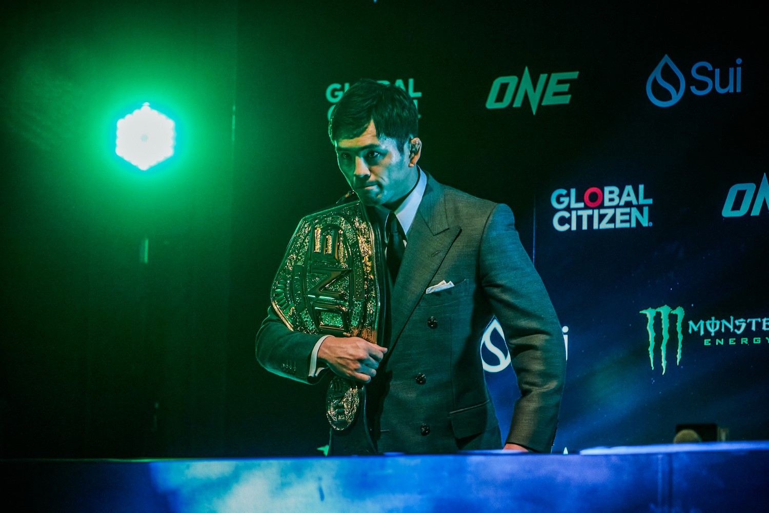 ONE Championship flyweight MMA champion Yuya Wakamatsu walks on stage with his belt at the ONE 173 press conference in Tokyo