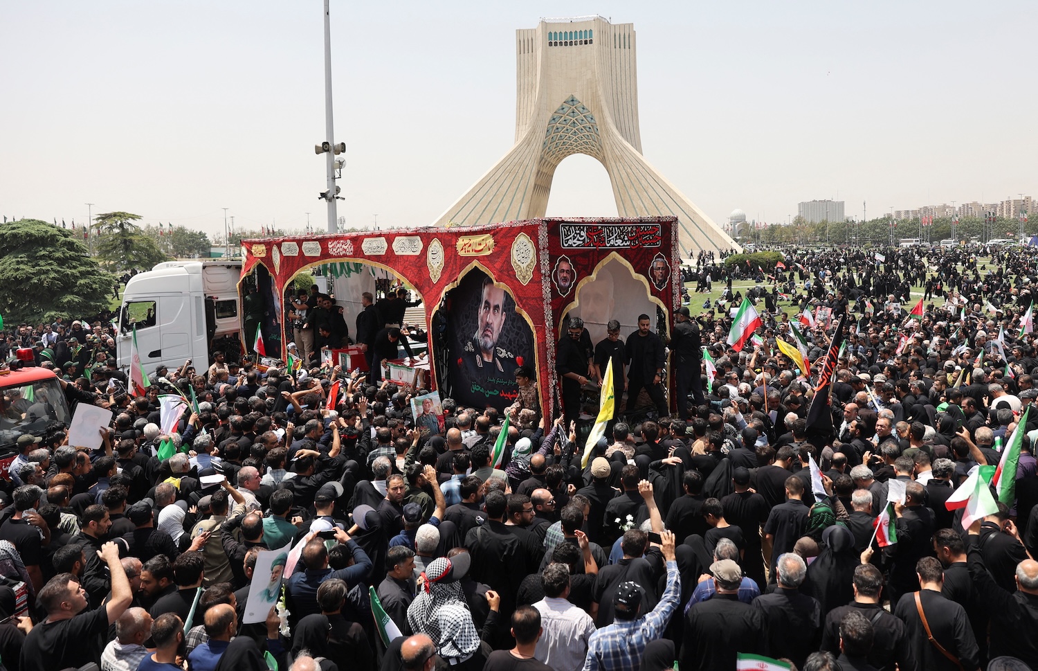 A large crowd surrounds a flatbed truck carrying the coffins of senior Iranian commanders killed in Israeli strikes, in Tehran on June 28. (Photo: Majid Asgaripour/West Asia News Agency via Reuters)