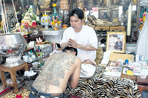 Ajarn Noo blesses a disciple. The master is renowned for his tattoos which he says offer protection. (Photo: Bangkok Post)