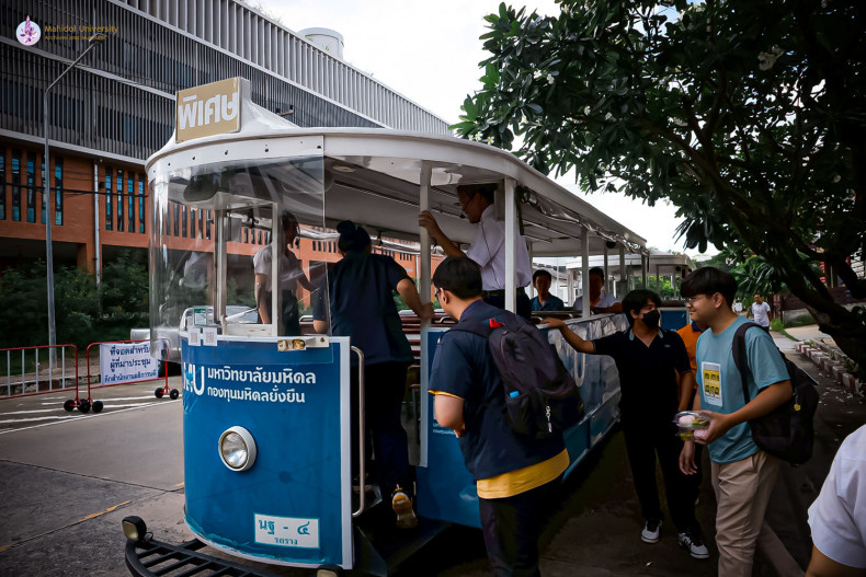 Mahidol University's iconic trams near the end of the road