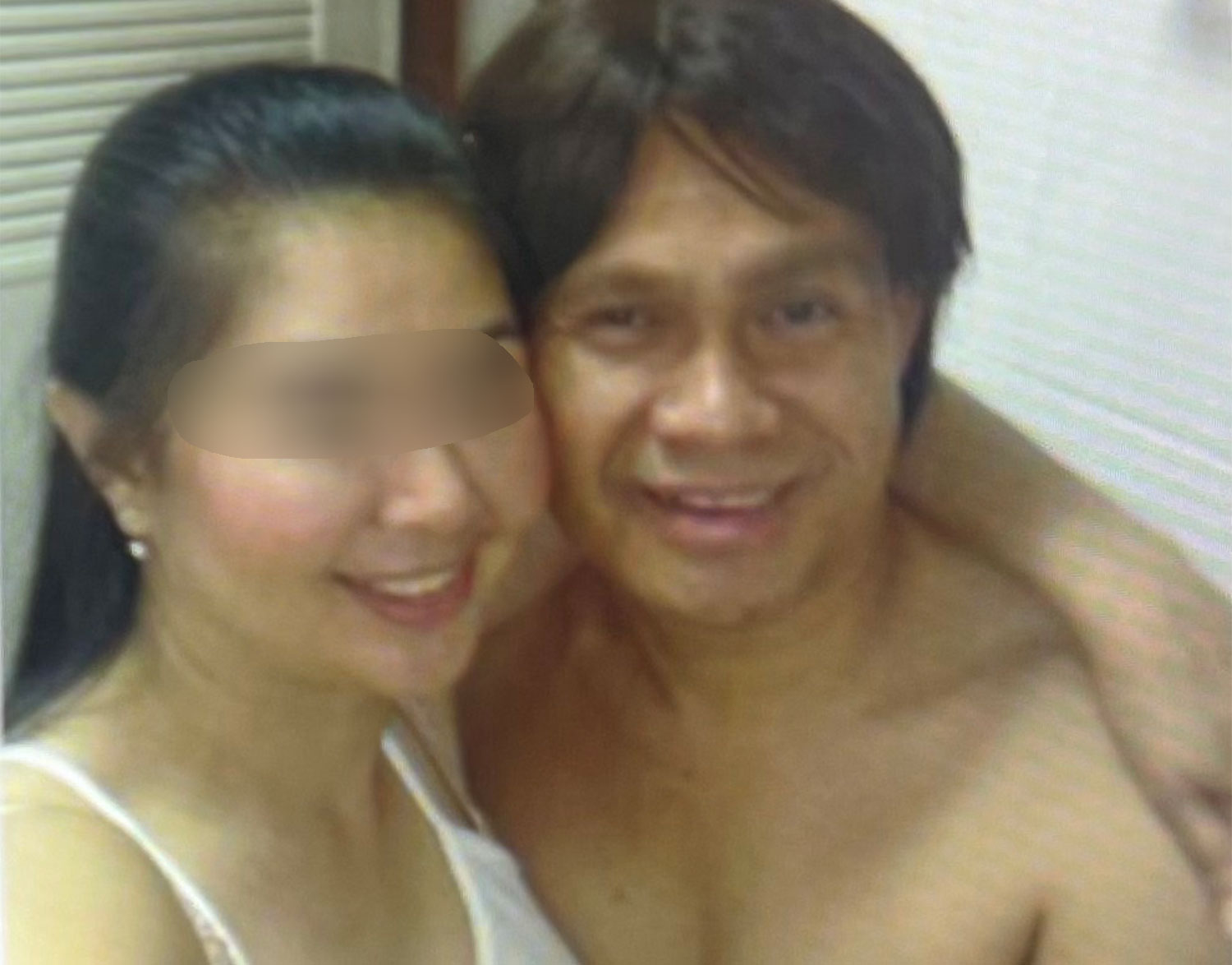 Phra Thamma Wachiratheerakhun, former abbot of Wat Nakhon Sawan, is seen in a wig while embracing a woman believed to be his partner.&thinsp;(Photo supplied/ Wassayos Ngamkham)