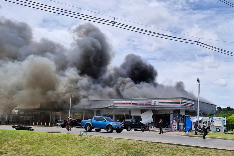 A BM21 rocket fired from Cambodia strikes a convenience store at a PTT petrol station in Ban Phue, Kantharalak district, Si Sa Ket, sparking a fire that killed eight people and injured 13 others on Thursday. The strike occurred as a school vehicle stopped for snacks en route to a bunker. The site is about 20km from the Thai–Cambodian border. (Photo courtesy of Kantharalak police station)