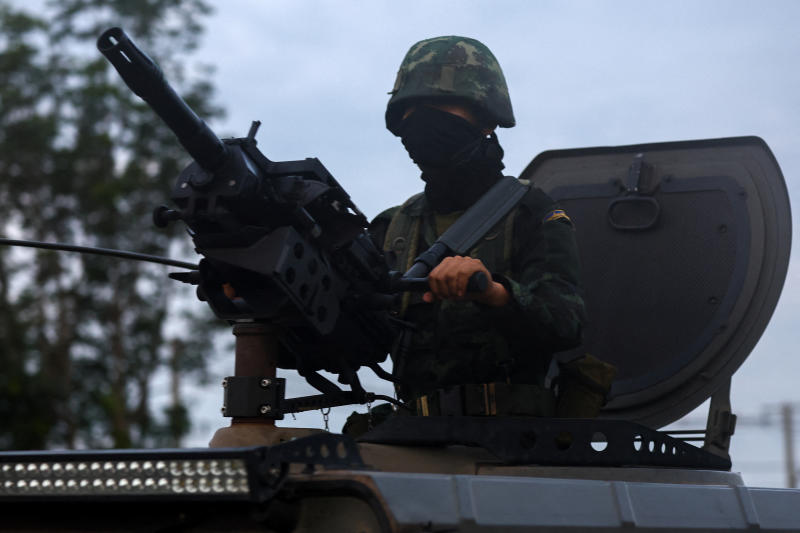 A soldier rides a military vehicle in Buriram province on Friday, after Thailand scrambled an F-16 fighter jet to bomb targets in Cambodia following artillery volleys from both sides. (Photo: Reuters)