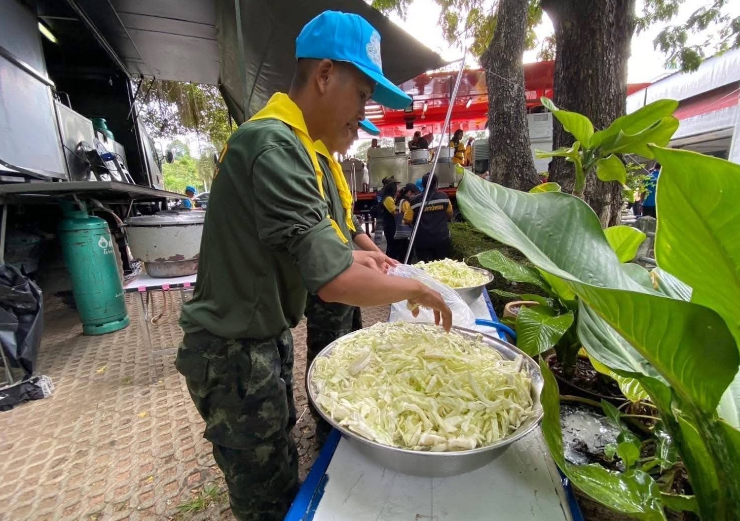 A Thai soldier works in a field kitchen set up for evacuees at the a temporary shelter at Surin Rajabhat University on Friday.