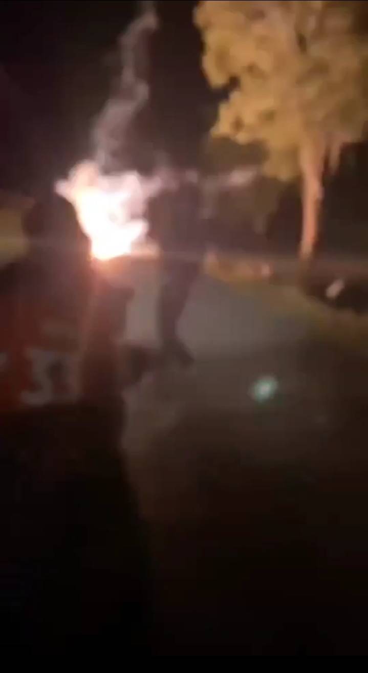 A screenshot from a video shows a youth gang throwing a ping pong bomb in the middle of the road. (Photo: Prasit Tangprasert)
