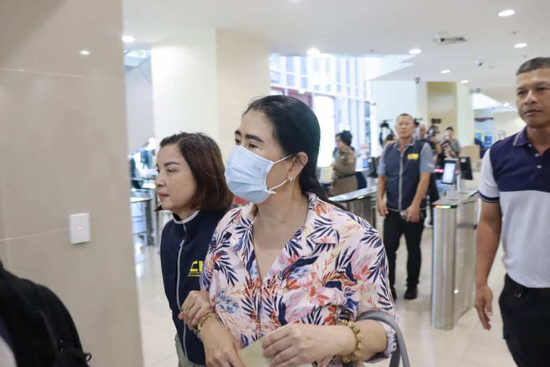 Phuthinee Kawinpaisarn, 57, is taken to the police Anti-Corruption Division for legal proceedings after being arrested at a residence in Pathum Thani province on Thursday. (Photo: Wassayos Ngamkham)