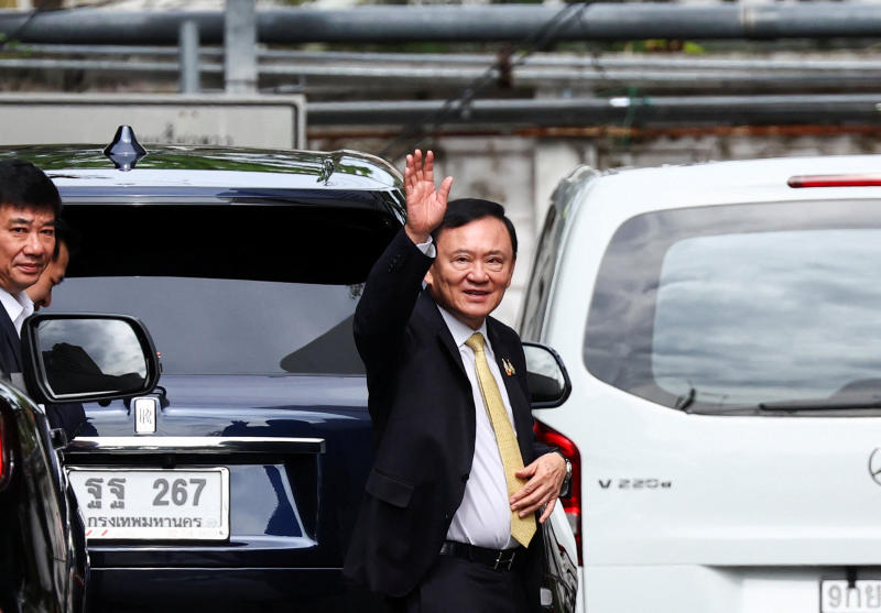 Former prime minister Thaksin Shinawatra leaves after the Criminal Court cleared him of charges in a lese majeste case on Friday. (Photo: Reuters)