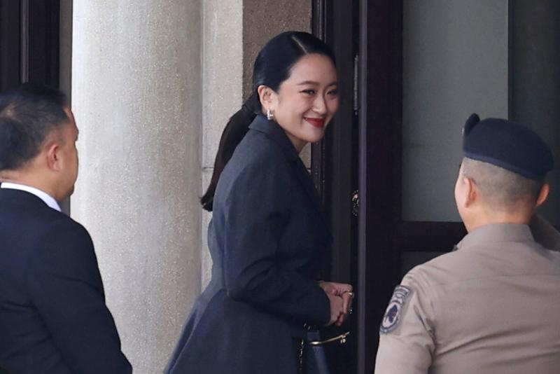 Prime Minister Paetongtarn Shinawatra is hugged by red-shirt supporters as she arrives at Pheu Thai Party headquarters in Bangkok after the Constitutional Court voted to dismiss her from office on Friday. (Photo: Nutthawat Wicheanbut)