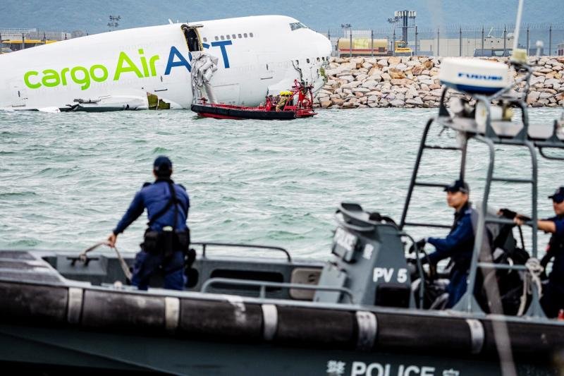Rescue workers at the wreckage of an ACT Airlines cargo aircraft operated for Emirates Airline near the runway at Hong Kong International Airport in Hong Kong on Monday. (Photo: Bloomberg)